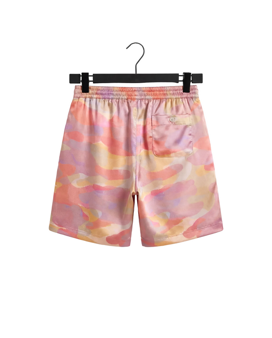 Colorful swim shorts hanging on a hanger against a white background