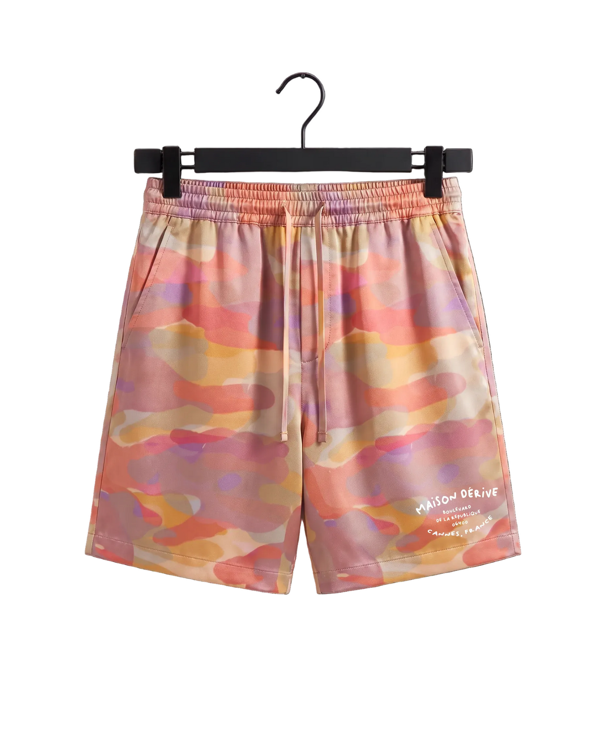 A pair of men's shorts featuring a colorful abstract watercolor camouflage pattern in shades of pink, orange, yellow, and purple. The shorts have an elastic waistband with a white drawstring and a white printed logo on the lower left leg.